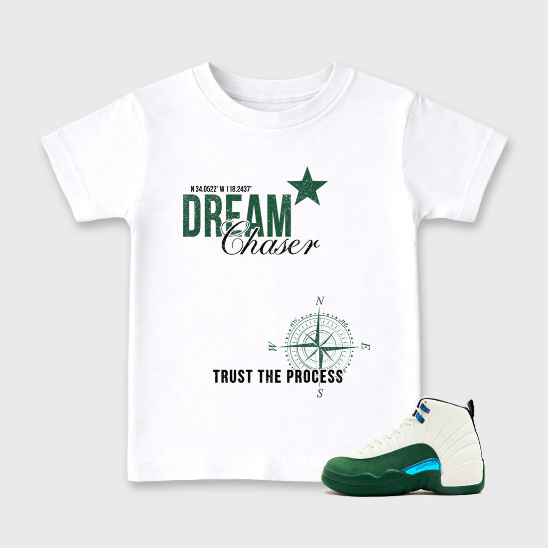 Dream Chaser Baby & Kids Graphic T-Shirt featuring original artwork designed to match the Air Jordan 12 Summit Green. White 1 Kids Graphic Tee.