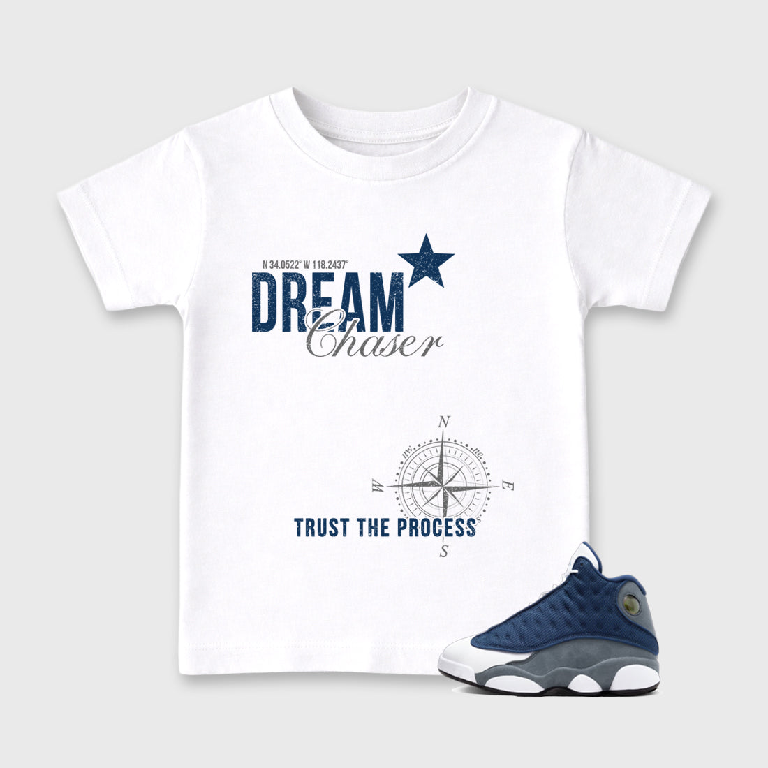 Dream Chaser Baby & Kids Graphic T-Shirt featuring original artwork designed to match the Air Jordan 13 Flint. White 1 Kids Graphic Tee.
