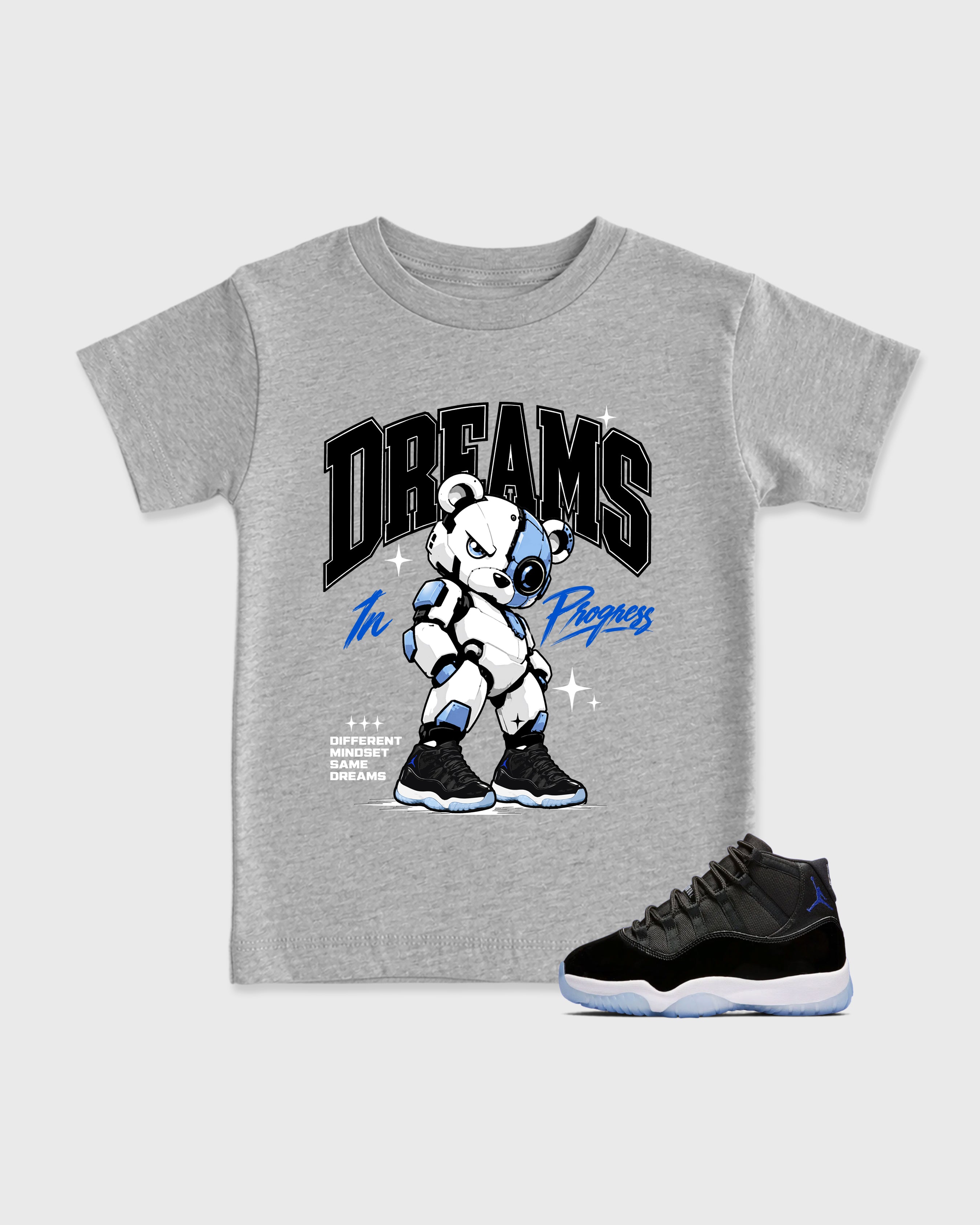 Dreams In Progress Baby & Kids Graphic T-Shirt featuring original artwork designed to match the Air Jordan 11 Space Jam. Heather Grey 1 Kids Graphic Tee.