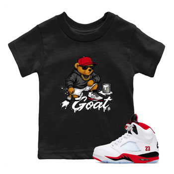 Drip The GOAT baby and kids t-shirt crafted for little sneakerheads to shine with the Jordan 5 Retro Fire Red sneakers, displayed in Black 1.