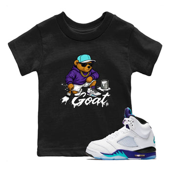 Drip The GOAT baby and kids t-shirt crafted for little sneakerheads to shine with the Jordan 5 Retro Grape sneakers, displayed in Black 1.
