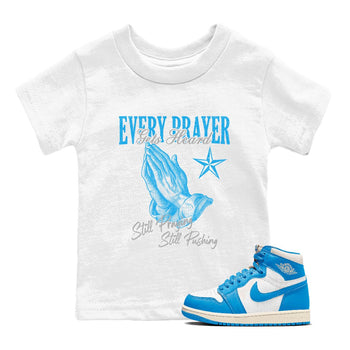 Every Prayer Gets Heard baby and kids t-shirt crafted for little sneakerheads to shine with the Air Jordan 1 UNC Reimagined sneakers, displayed in White 1.