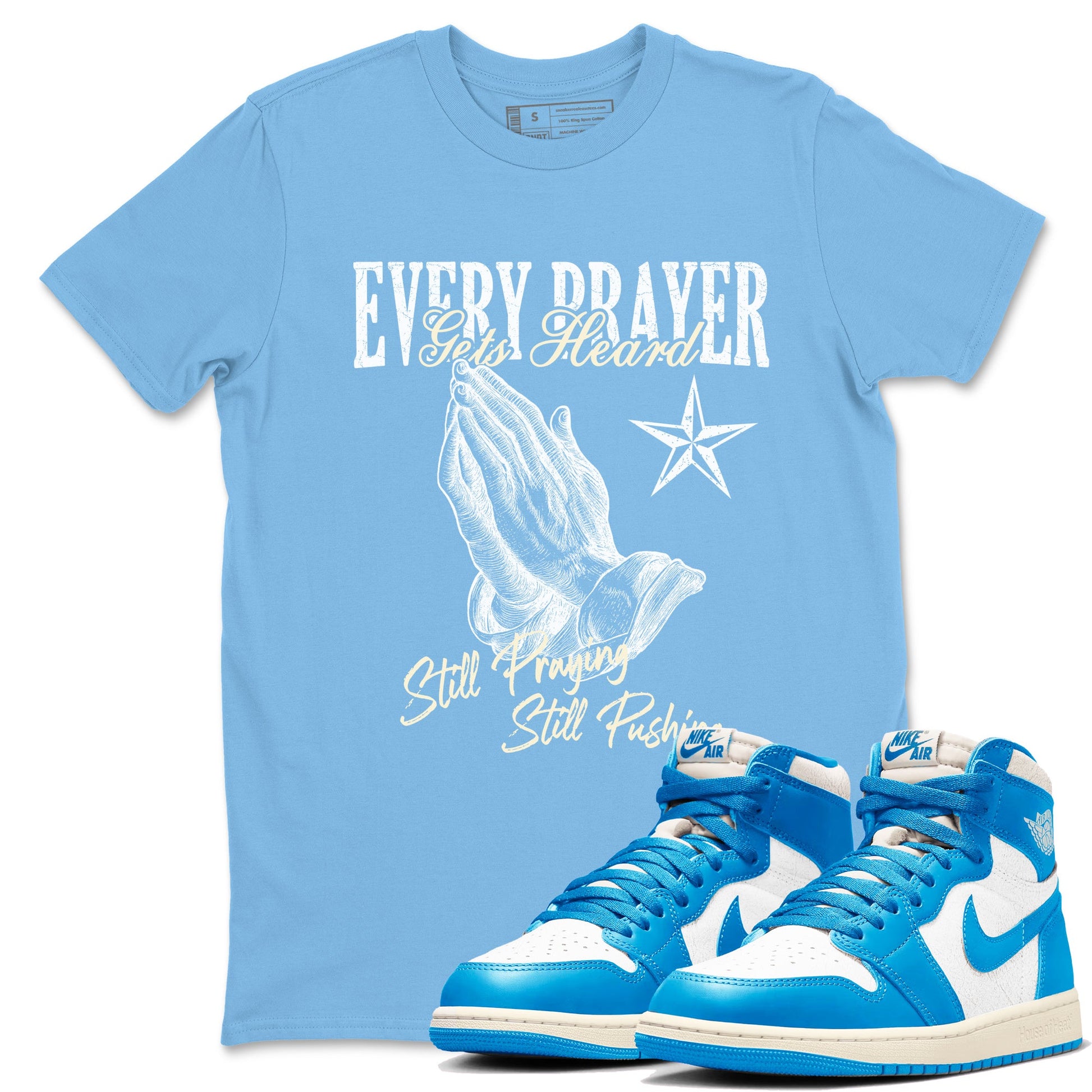 Every Prayer Gets Heard sneaker match t-shirt styled to complete your fit with the Air Jordan 1 UNC Reimagined sneakers, shown in Carolina Blue 1.