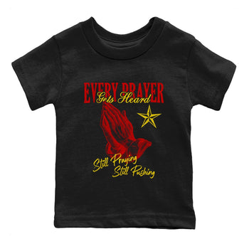 Every Prayer Gets Heard baby and kids t-shirt crafted for little sneakerheads to shine with the Air Jordan 14 Challenge Red sneakers, AJ14 Ferrari,  displayed in Black 2.