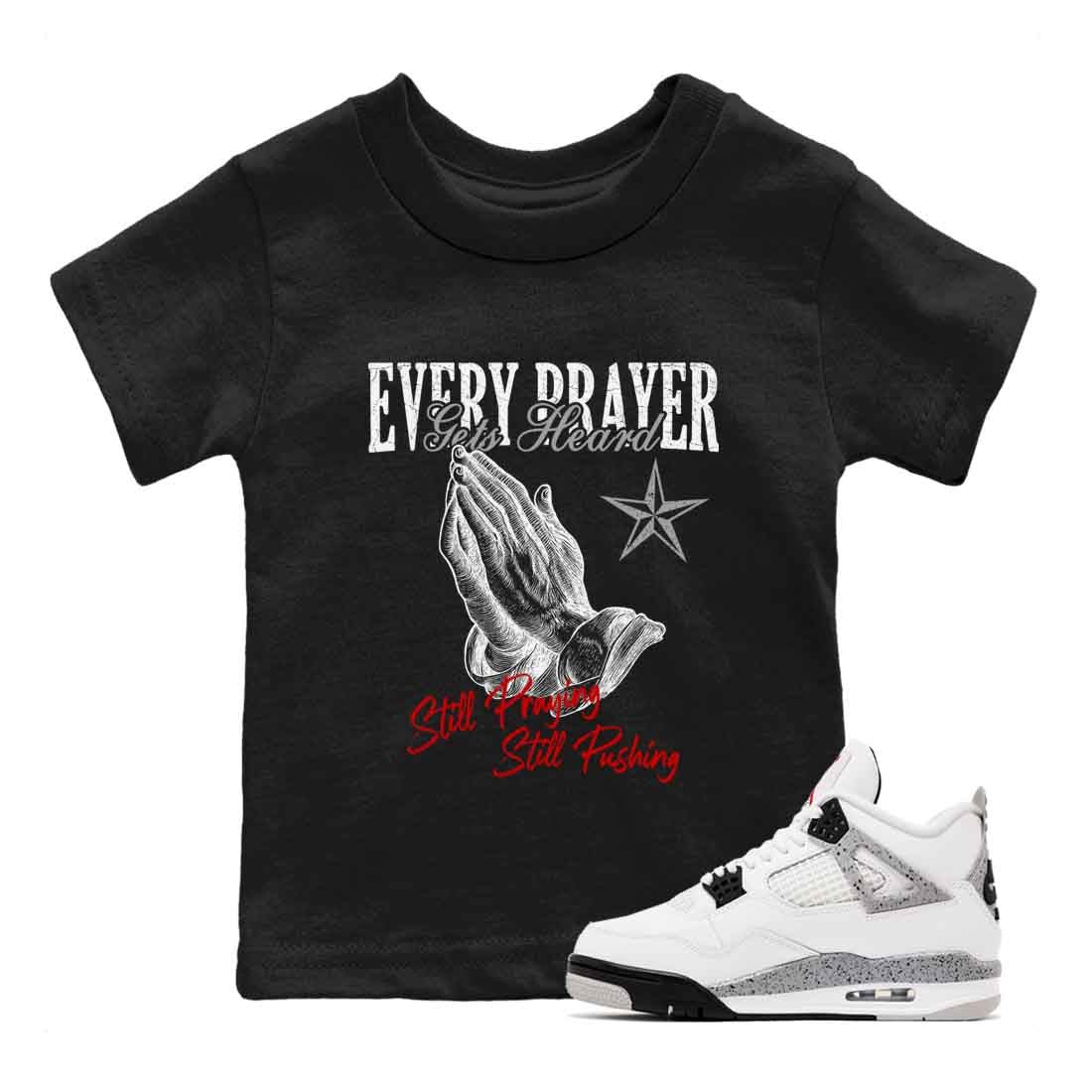 Every Prayer Gets Heard baby and kids t-shirt crafted for little sneakerheads to shine with the Air Jordan 4 White Cement sneakers, displayed in Black 1.