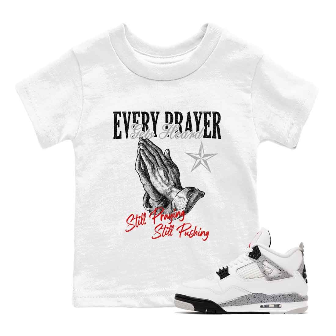 Every Prayer Gets Heard baby and kids t-shirt crafted for little sneakerheads to shine with the Air Jordan 4 White Cement sneakers, displayed in White 1.