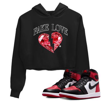 Fake Love womens crop tee made to vibe with the Air Jordan 1 Ruby sneakers — the perfect match in Black 1.