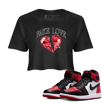 Fake Love womens crop tee made to vibe with the Air Jordan 1 Ruby sneakers — the perfect match in Black 1.