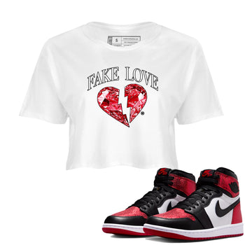 Fake Love womens crop tee made to vibe with the Air Jordan 1 Ruby sneakers — the perfect match in White 1.