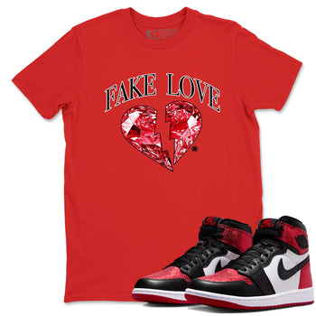 Fake Love sneaker match t-shirt styled to complete your fit with the Air Jordan 1 Ruby sneakers, shown in Red 1.