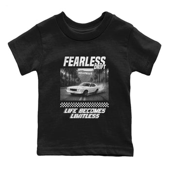 Fearless Drift baby and kids t-shirt crafted for little sneakerheads to shine with the Air Foamposite One Triple White sneakers, displayed in Black 2.