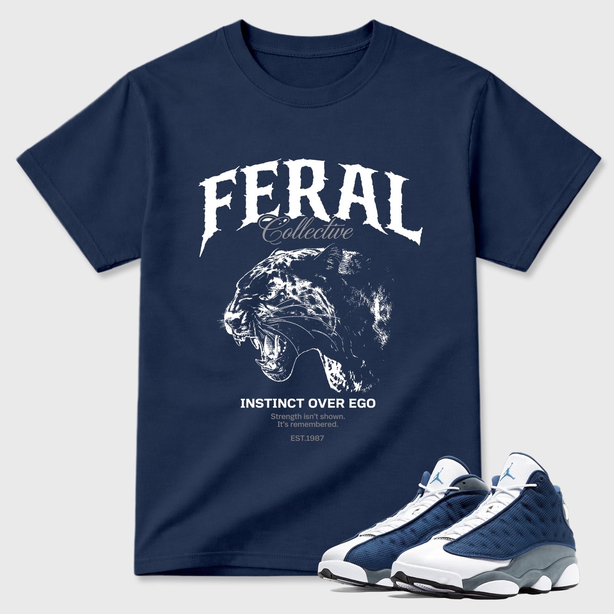 Feral Collective Graphic T-Shirt featuring original streetwear artwork designed to match the Air Jordan 13 Flint. Navy 1 Graphic T-Shirt.