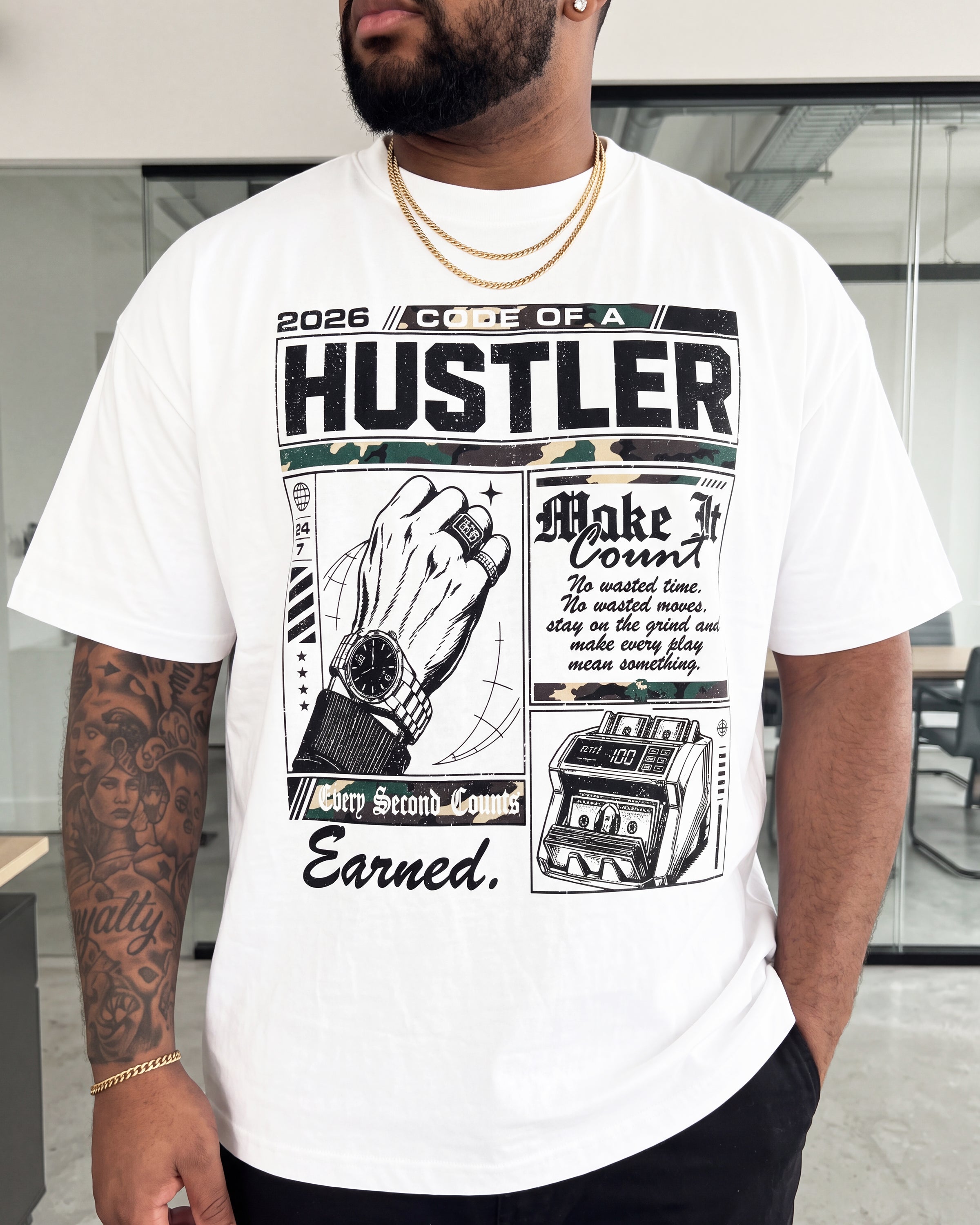 A man wearing a white graphic t-shirt with a black and gray print that reads '2026 COPIE OF A HUSTLER' and includes illustrations of a hand, watch, and cash register.