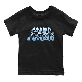 Foams baby and kids t-shirt crafted for little sneakerheads to shine with the Air Foamposite One Psychic Blue sneakers, displayed in Black 2.