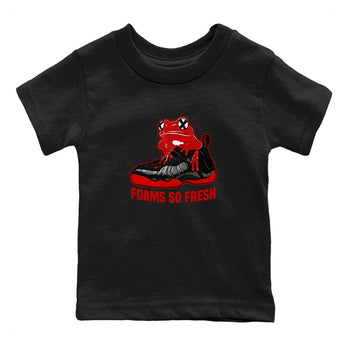 Foams So Fresh baby and kids t-shirt crafted for little sneakerheads to shine with the Air Foamposite Cough Drop sneakers, displayed in Black 2.