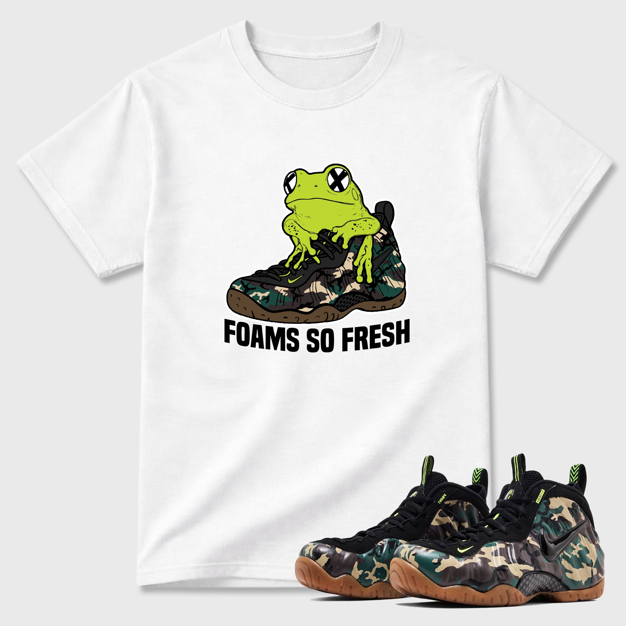 Foams So Fresh Graphic T-Shirt featuring original streetwear artwork designed to match the Air Foamposite Pro Green Camo. White 1 Graphic T-Shirt.