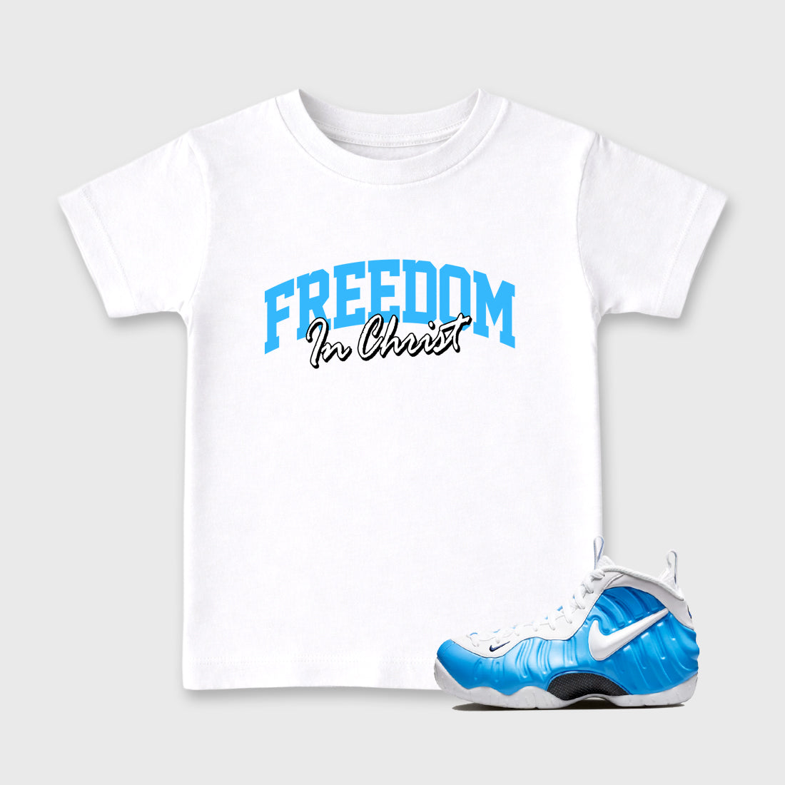 Best Sneakerfit Graphic Tee. Graphic Outfits. Sneaker Tees To Match Air Foamposite Pro University Blue Sneakers – Freedom In Christ Kids T-Shirt White 1