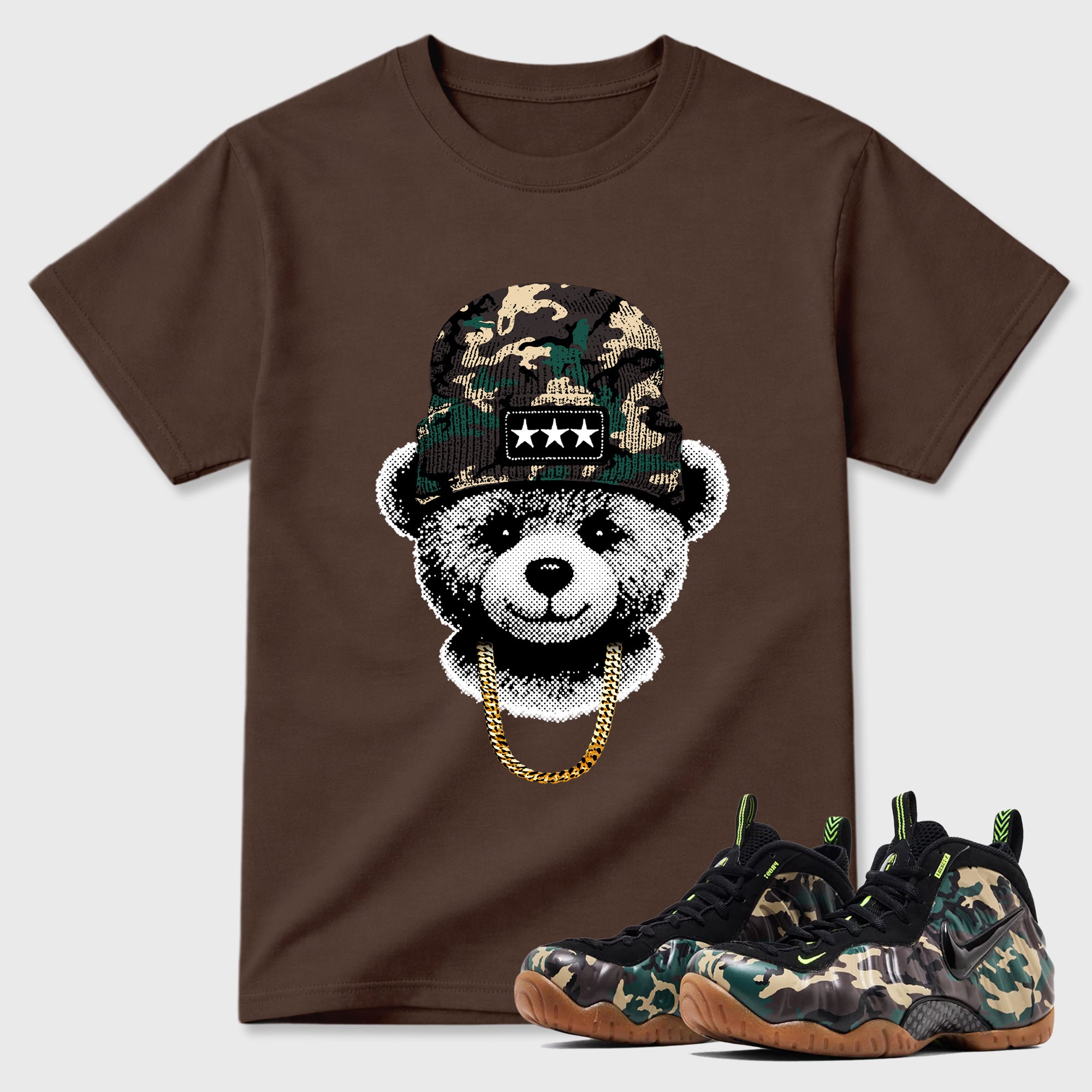 Gangster Teddy Graphic T-Shirt featuring original streetwear artwork designed to match the Air Foamposite Pro Green Camo. Dark Chocolate 1 Graphic T-Shirt.