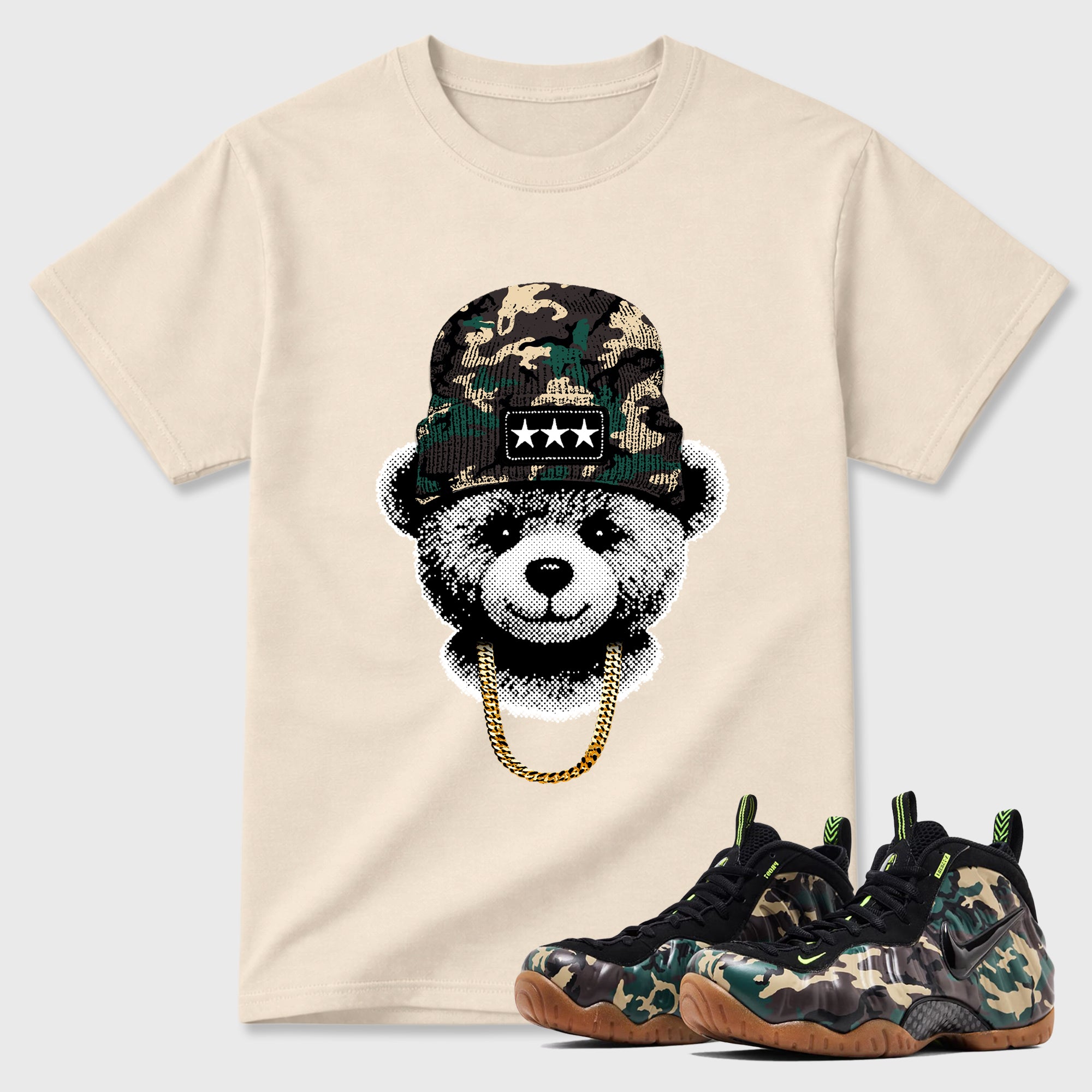 Gangster Teddy Graphic T-Shirt featuring original streetwear artwork designed to match the Air Foamposite Pro Green Camo. Natural 1 Graphic T-Shirt.