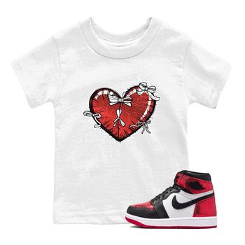 Heart With Ribbons baby and kids t-shirt crafted for little sneakerheads to shine with the Air Jordan 1 Ruby sneakers, displayed in White 1.
