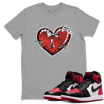 Heart With Ribbons sneaker match t-shirt styled to complete your fit with the Air Jordan 1 Ruby sneakers, shown in Heather Grey 1.