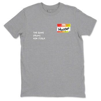 Sneaker Threads – Sneaker Tees To Match Nike JA 3 Under The Christmas Tree – Hooper Badge Graphic Tee Heather Grey 2. Perfect for Jordan releases 2025 colorways. Perfect for Ja Morant sneaker releases and Christmas 2025 colorways.