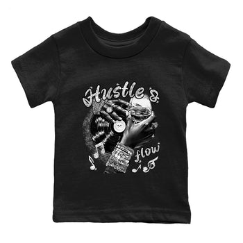 Hustle And Flow baby and kids t-shirt crafted for little sneakerheads to shine with the Air Foamposite One Triple White sneakers, displayed in Black 2.