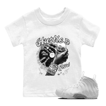 Hustle And Flow baby and kids t-shirt crafted for little sneakerheads to shine with the Air Foamposite One Triple White sneakers, displayed in White 1.