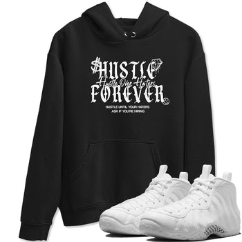 Hustle Over Haters sneaker match t-shirt styled to complete your fit with the Air Foamposite One Triple White sneakers, shown in Black 1.