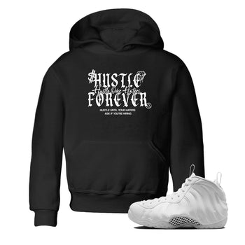 Hustle Over Haters baby and kids t-shirt crafted for little sneakerheads to shine with the Air Foamposite One Triple White sneakers, displayed in Black 1.
