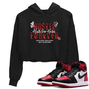 Hustle Over haters womens crop tee made to vibe with the Air Jordan 1 Ruby sneakers — the perfect match in Black 1.