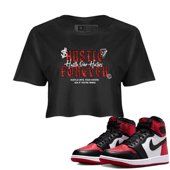Hustle Over haters womens crop tee made to vibe with the Air Jordan 1 Ruby sneakers — the perfect match in Black 1.