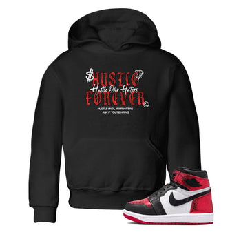 Hustle Over haters baby and kids t-shirt crafted for little sneakerheads to shine with the Air Jordan 1 Ruby sneakers, displayed in Black 1.
