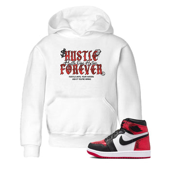 Hustle Over haters baby and kids t-shirt crafted for little sneakerheads to shine with the Air Jordan 1 Ruby sneakers, displayed in White 1.