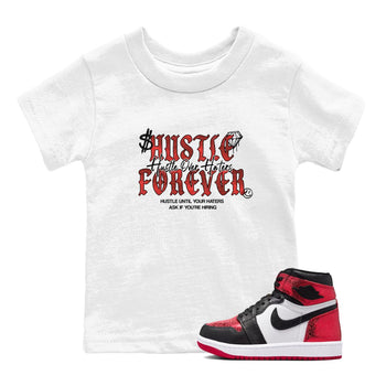 Hustle Over haters baby and kids t-shirt crafted for little sneakerheads to shine with the Air Jordan 1 Ruby sneakers, displayed in White 1.