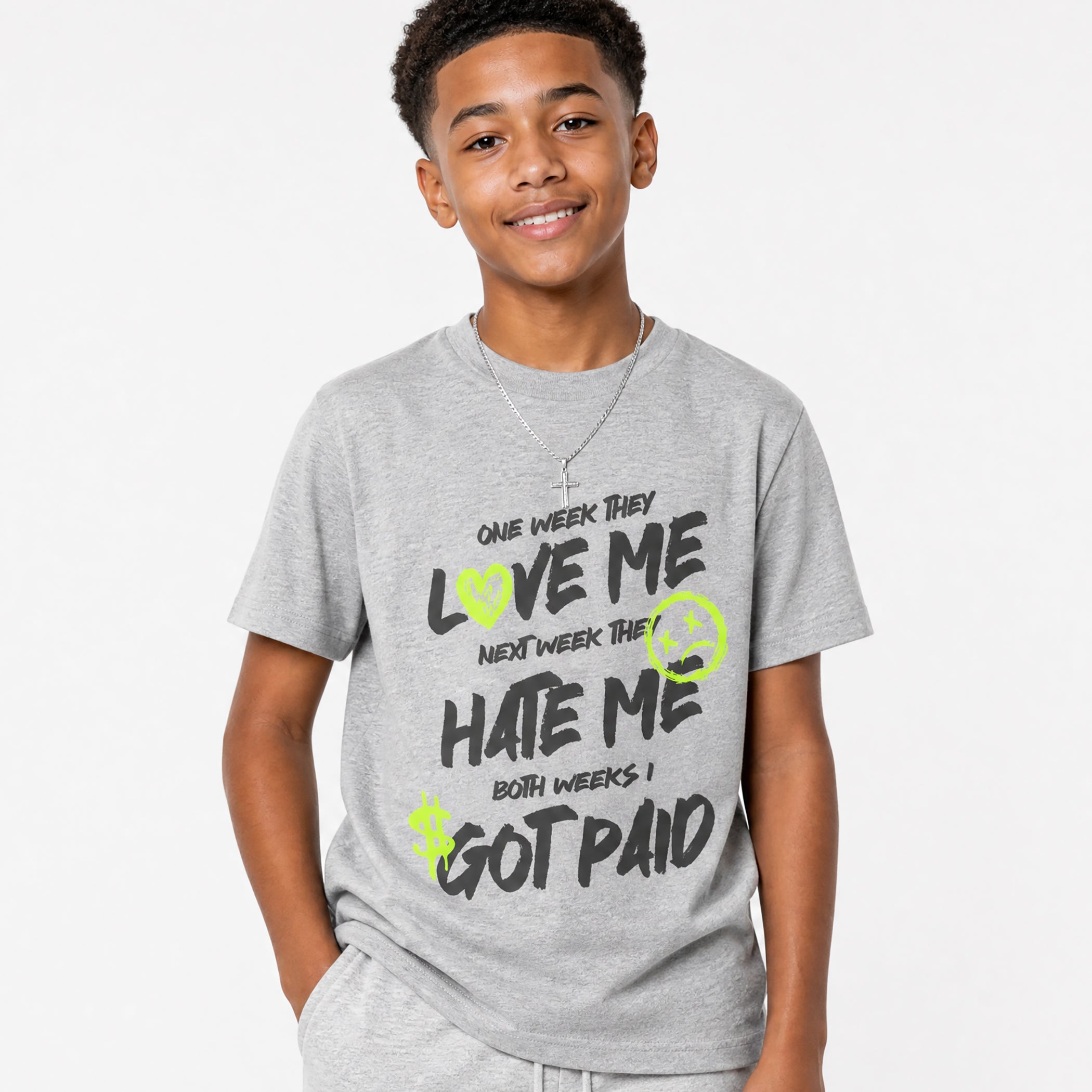 Child wearing a gray t-shirt with i got paid text design on a plain background