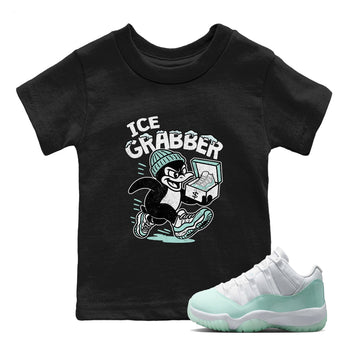 Ice Grabber baby and kids t-shirt crafted for little sneakerheads to shine with the Air Jordan 11 Igloo sneakers, displayed in Black 1.