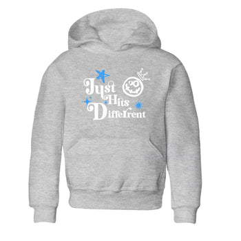 Just Hits Different baby and kids t-shirt crafted for little sneakerheads to shine with the Air Jordan 12 White and University Blue sneakers, displayed in Heather Grey 2.
