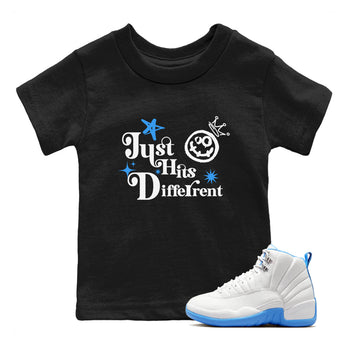 Just Hits Different baby and kids t-shirt crafted for little sneakerheads to shine with the Air Jordan 12 White and University Blue sneakers, displayed in Black 1.