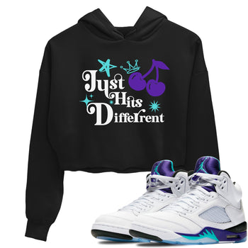 Just Hits Different womens crop tee made to vibe with the Air Jordan 5 Grape sneakers — the perfect match in Black 1.