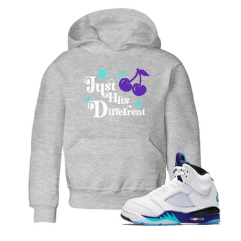 Just Hits Different baby and kids t-shirt crafted for little sneakerheads to shine with the Air Jordan 5 Grape sneakers, displayed in Heather Grey 1.
