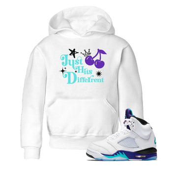 Just Hits Different baby and kids t-shirt crafted for little sneakerheads to shine with the Air Jordan 5 Grape sneakers, displayed in White 1.