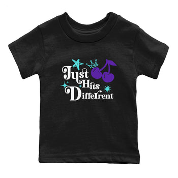 Just Hits Different baby and kids t-shirt crafted for little sneakerheads to shine with the Air Jordan 5 Grape sneakers, displayed in Black 2.