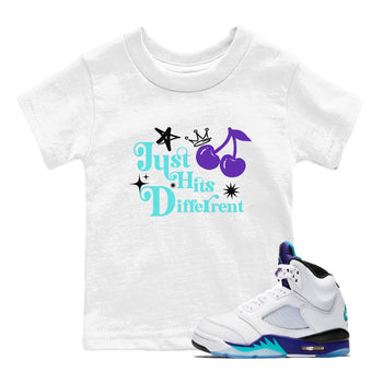 Just Hits Different baby and kids t-shirt crafted for little sneakerheads to shine with the Air Jordan 5 Grape sneakers, displayed in White 1.