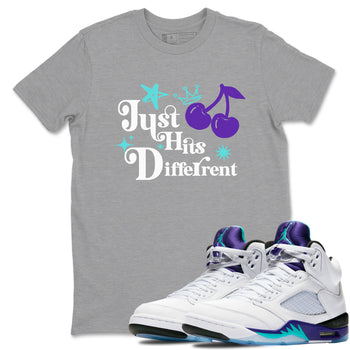 Just Hits Different sneaker match t-shirt styled to complete your fit with the Air Jordan 5 Grape sneakers, shown in Heather Grey 1.