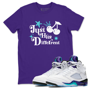 Just Hits Different sneaker match t-shirt styled to complete your fit with the Air Jordan 5 Grape sneakers, shown in Purple 1.