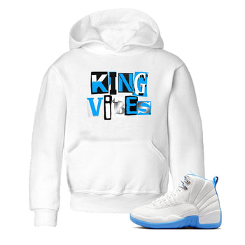 King Vibes baby and kids t-shirt crafted for little sneakerheads to shine with the Air Jordan 12 White and University Blue sneakers, displayed in White 1.