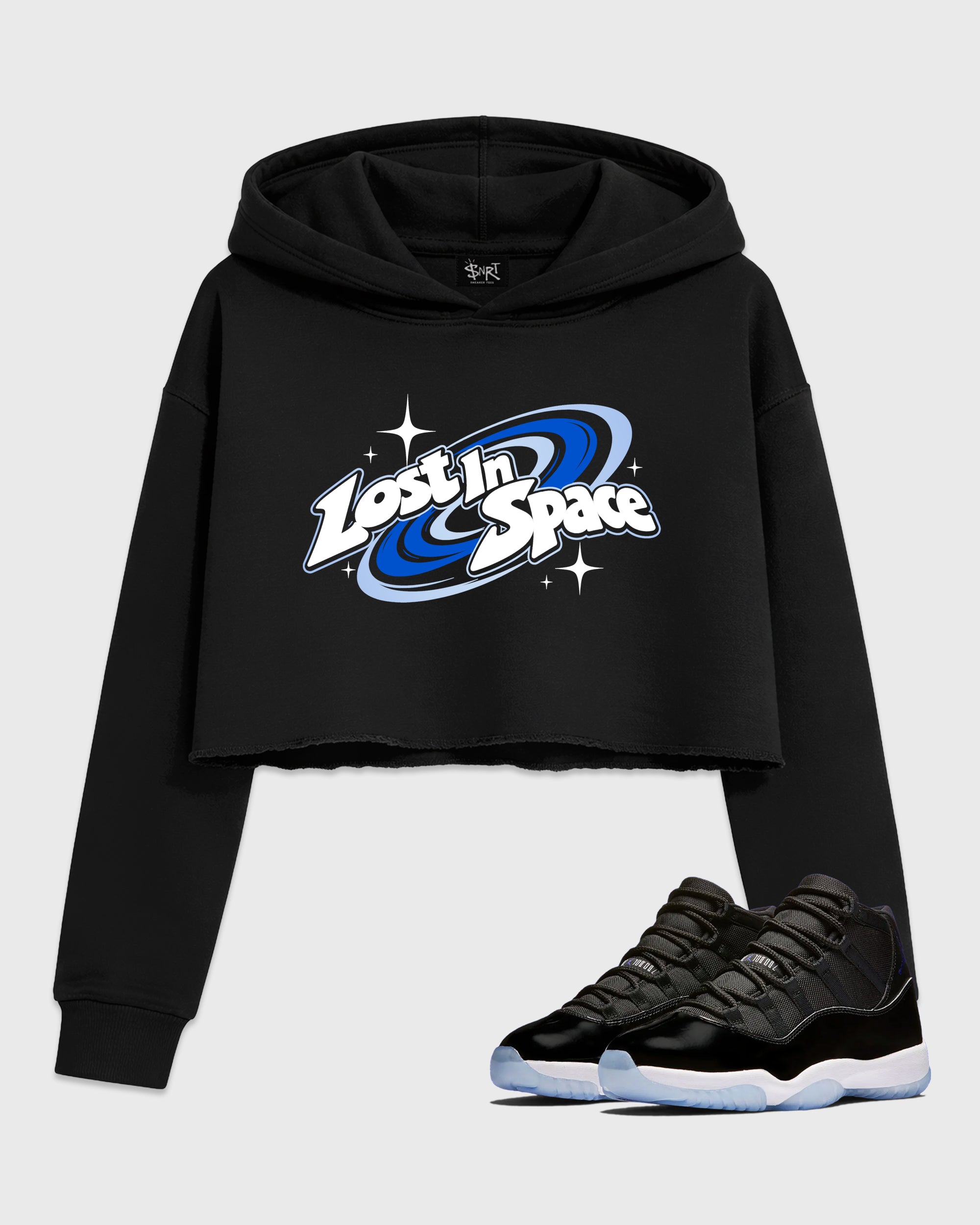 Lost in Space Women’s Graphic Crop Tee featuring original streetwear artwork designed to match the Air Jordan 11 Space Jam. Black 1 Crop Tee.