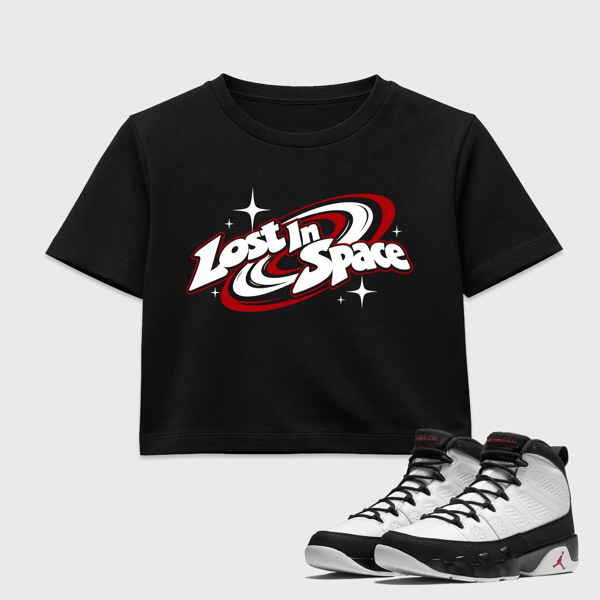 Lost in Space women’s crop tee designed to match the Air Jordan 9 True Red, featuring coordinated Black 1 options for a perfect streetwear vibe.