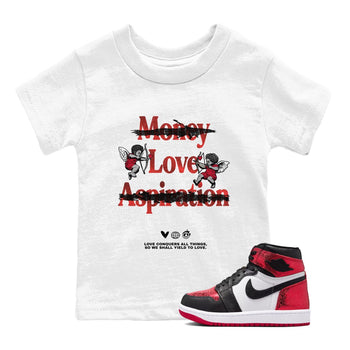 Love Conquers All Things baby and kids t-shirt crafted for little sneakerheads to shine with the Air Jordan 1 Ruby sneakers, displayed in White 1.